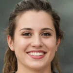 Smiling young woman with brown hair and brown eyes